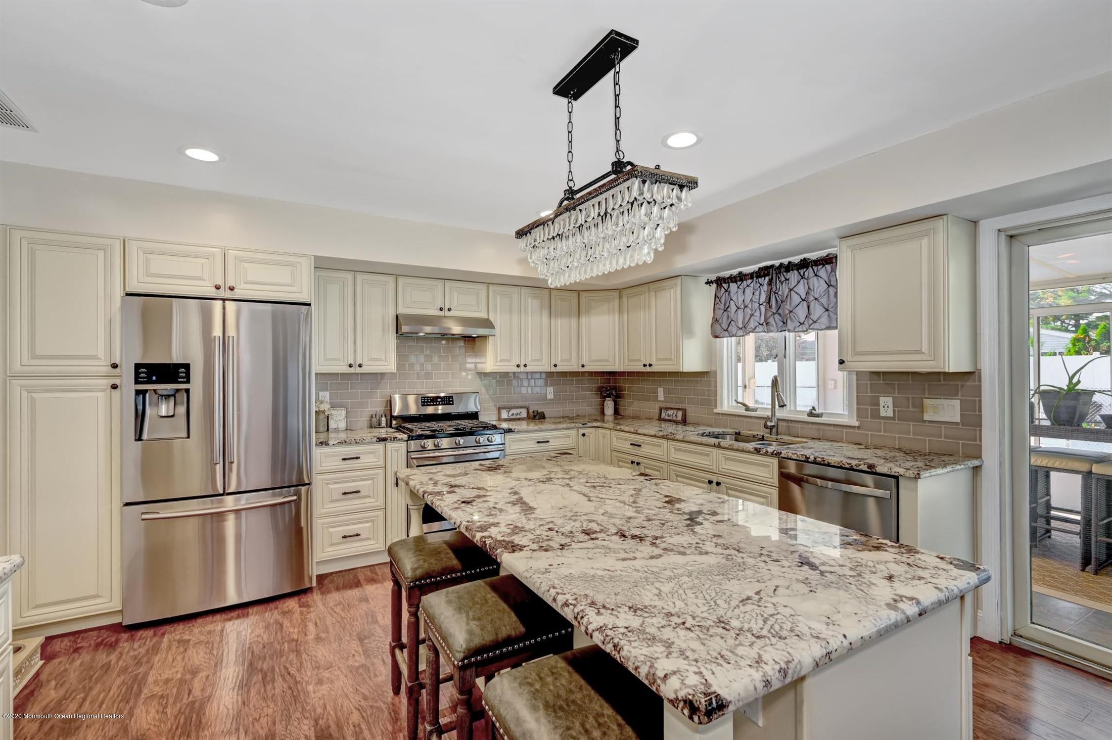 27 Sugar Bush Road Howell, NJ 07731 - Photo 19 of 46 a kitchen with stainless steel appliances granite countertop a sink refrigerator and cabinets