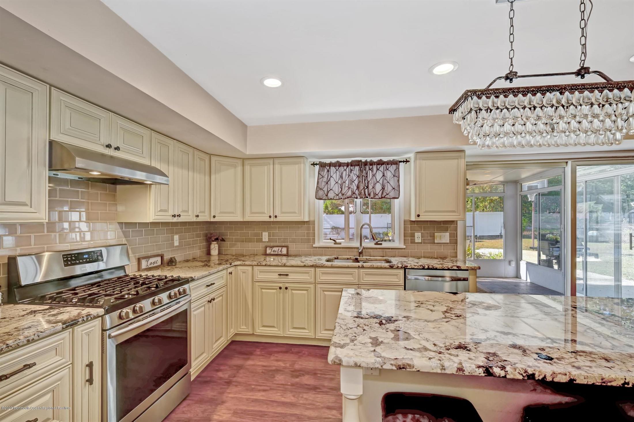 27 Sugar Bush Road Howell, NJ 07731 - Photo 20 of 46 a kitchen with stainless steel appliances granite countertop a stove sink and cabinets