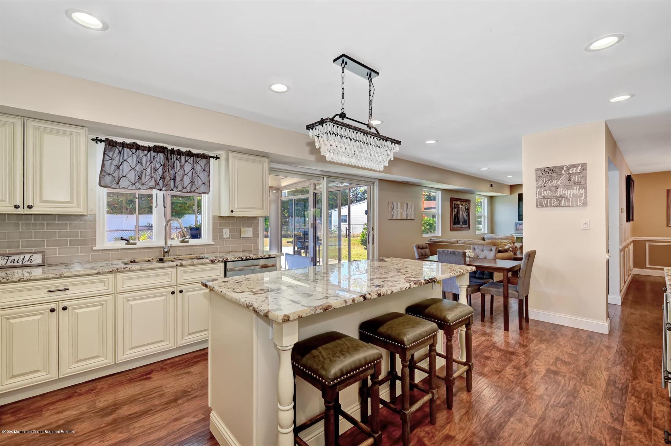 27 Sugar Bush Road Howell, NJ 07731 - Photo 21 of 46 a kitchen with a dining table chairs stainless steel appliances and cabinets