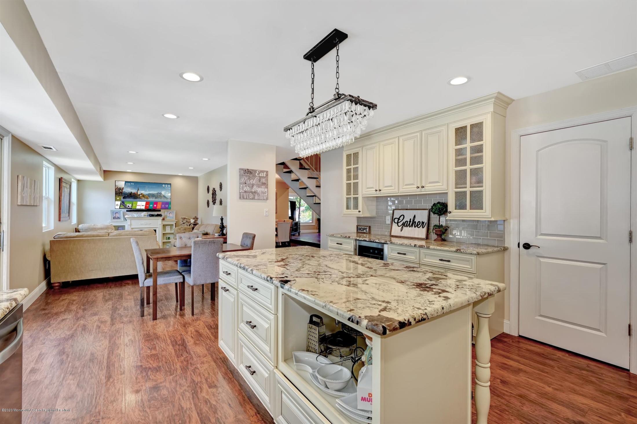27 Sugar Bush Road Howell, NJ 07731 - Photo 22 of 46 a open kitchen with stainless steel appliances granite countertop a stove and refrigerator
