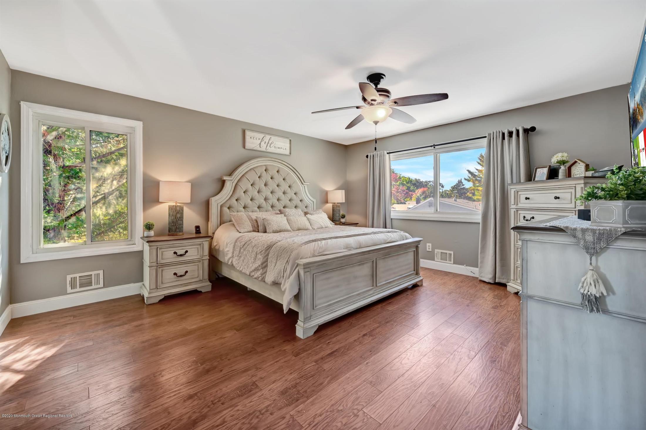 27 Sugar Bush Road Howell, NJ 07731 - Photo 26 of 46 a bedroom with a large bed and a chandelier
