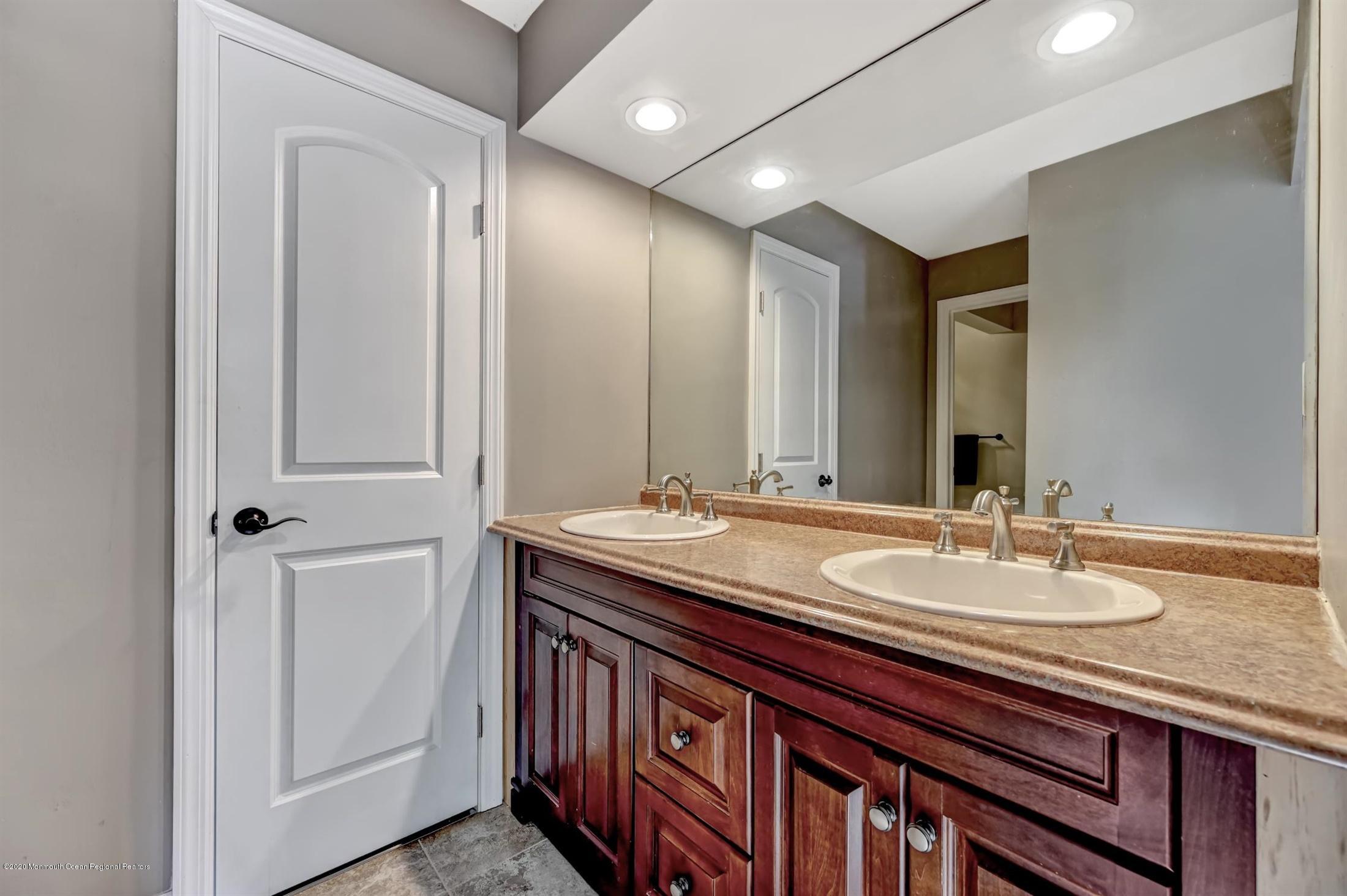 27 Sugar Bush Road Howell, NJ 07731 - Photo 28 of 46 a bathroom with a double vanity sink and a mirror
