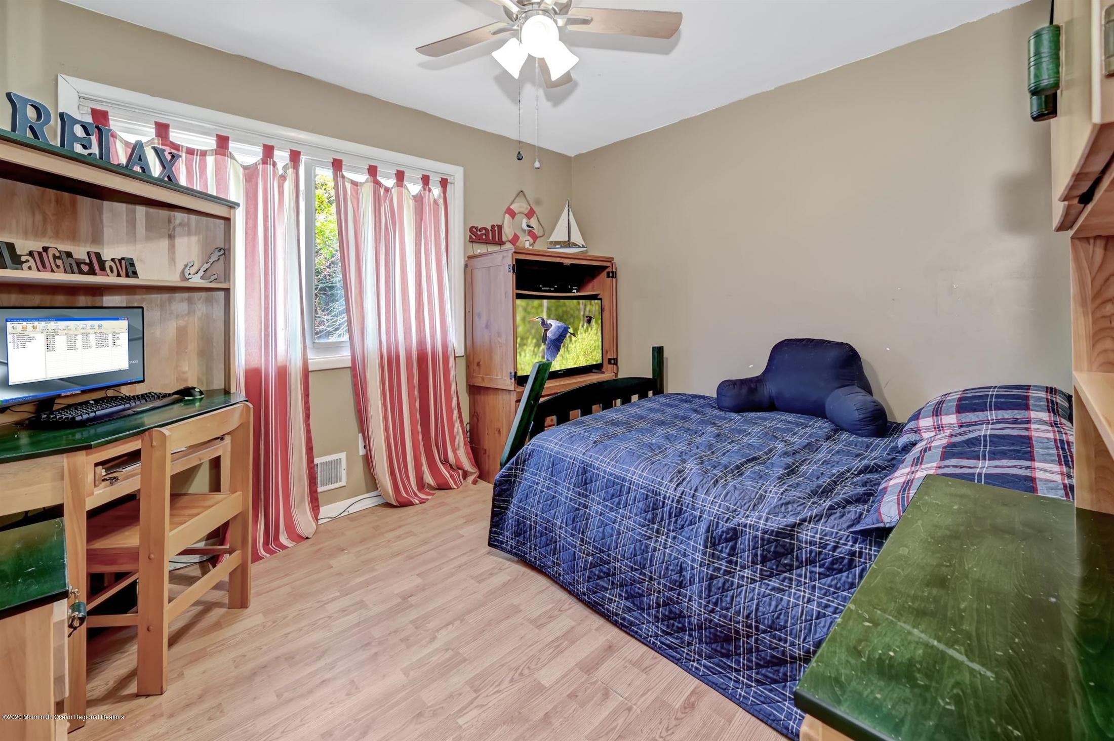 27 Sugar Bush Road Howell, NJ 07731 - Photo 32 of 46 a bedroom with a bed and a flat screen tv