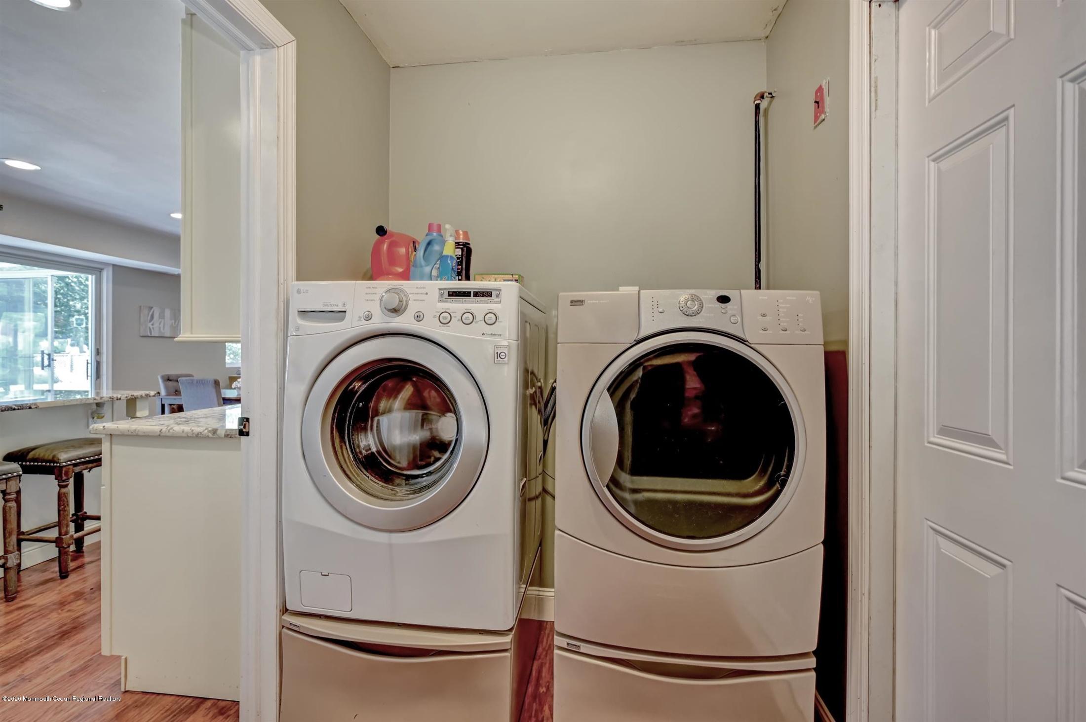 27 Sugar Bush Road Howell, NJ 07731 - Photo 36 of 46 a view of a hallway with washer and dryer