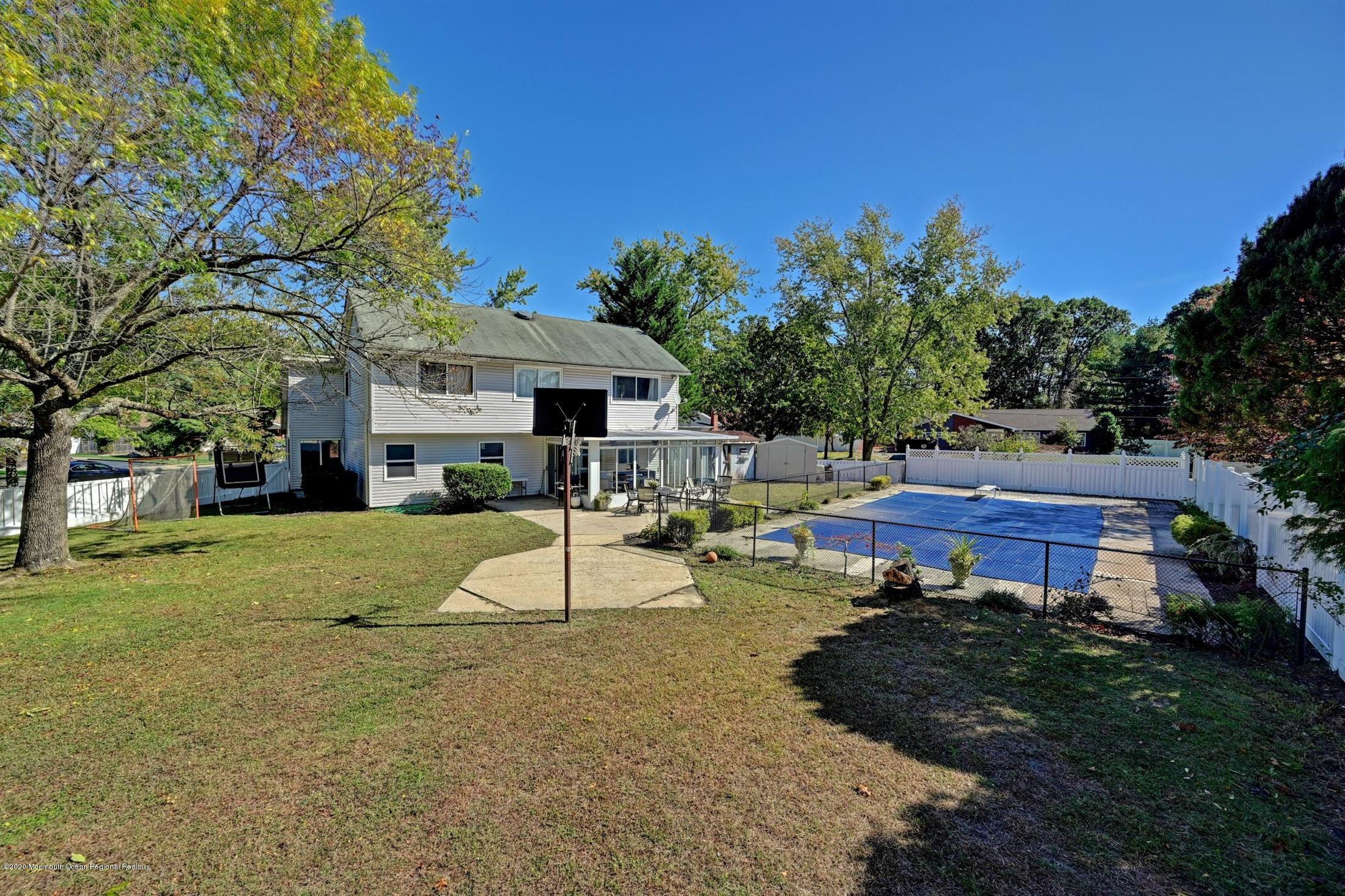27 Sugar Bush Road Howell, NJ 07731 - Photo 42 of 46 a view of a house with a yard patio and fire pit