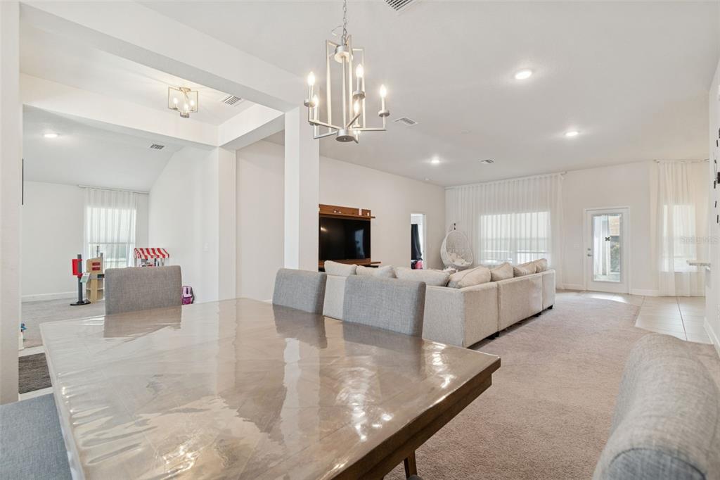 10358 Musa Road Spring Hill, FL 34608 - Photo 12 of 48 a living room with furniture and a chandelier