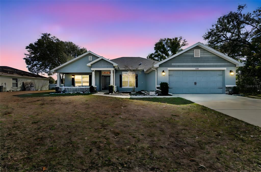 10358 Musa Road Spring Hill, FL 34608 - Photo 2 of 48 a front view of a house with a yard