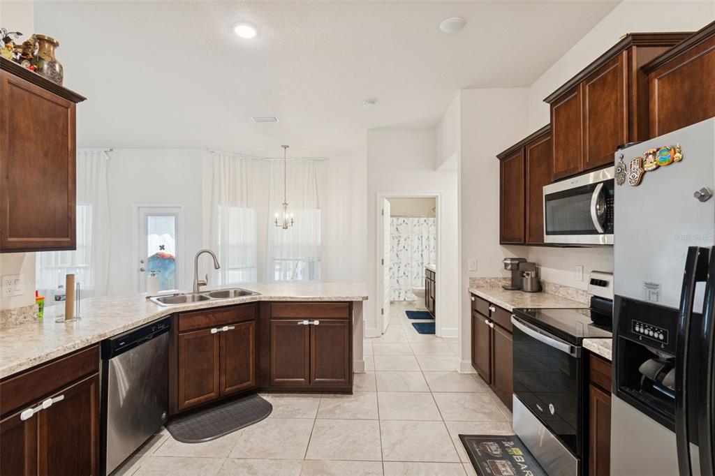 10358 Musa Road Spring Hill, FL 34608 - Photo 21 of 48 a kitchen with a sink stove and microwave