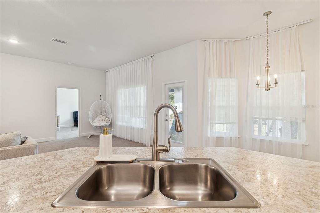 10358 Musa Road Spring Hill, FL 34608 - Photo 23 of 48 a kitchen with a sink and a counter top space