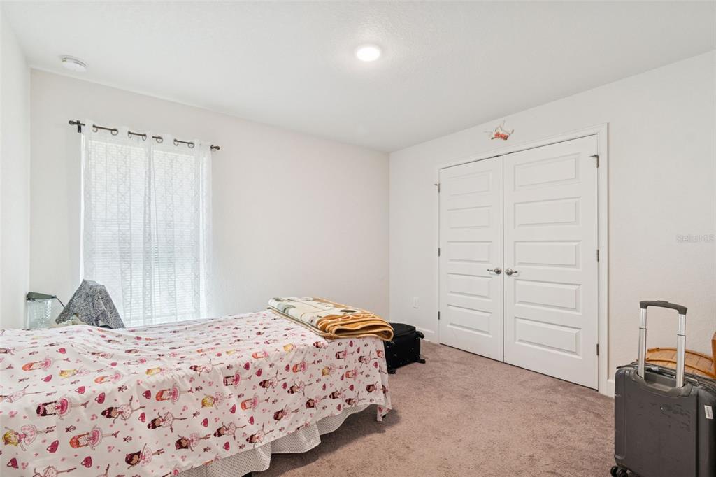 10358 Musa Road Spring Hill, FL 34608 - Photo 25 of 48 a bedroom with a bed and a dresser