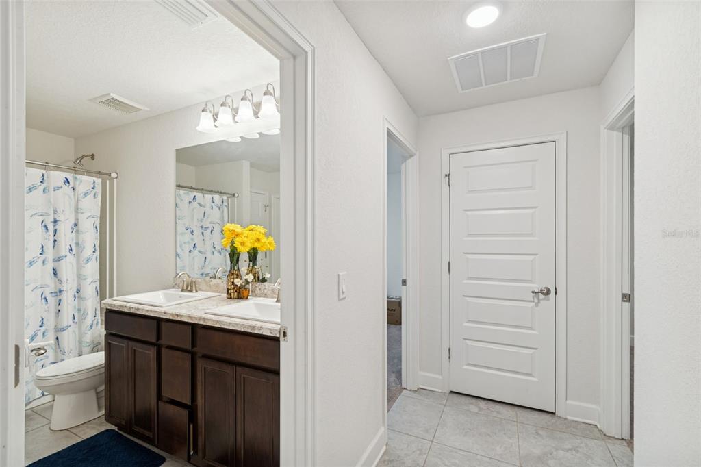 10358 Musa Road Spring Hill, FL 34608 - Photo 29 of 48 a bathroom with a sink vanity and mirror