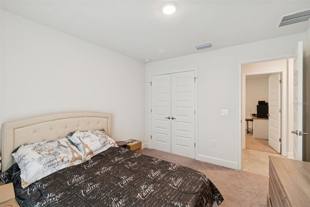 10358 Musa Road Spring Hill, FL 34608 - Photo 32 of 48 a bedroom with a bed and a view of bedroom