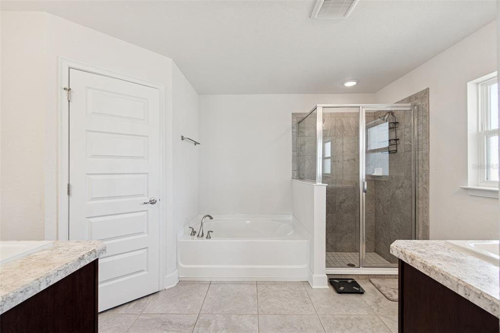 10358 Musa Road Spring Hill, FL 34608 - Photo 36 of 48 a bathroom with a granite countertop sink a toilet and bathtub