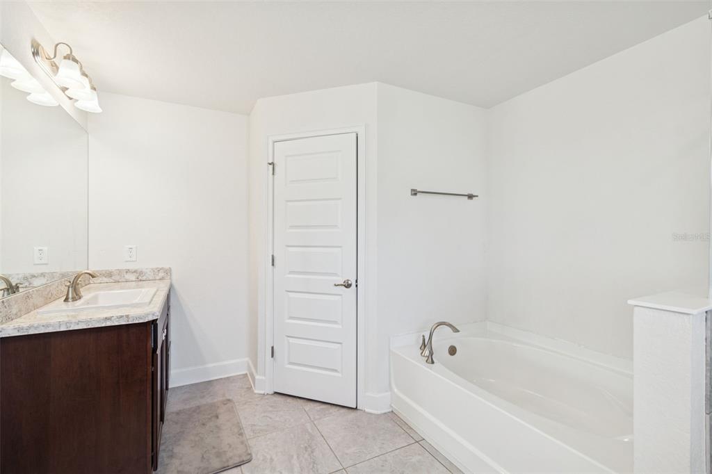 10358 Musa Road Spring Hill, FL 34608 - Photo 37 of 48 a bathroom with a bathtub and a sink