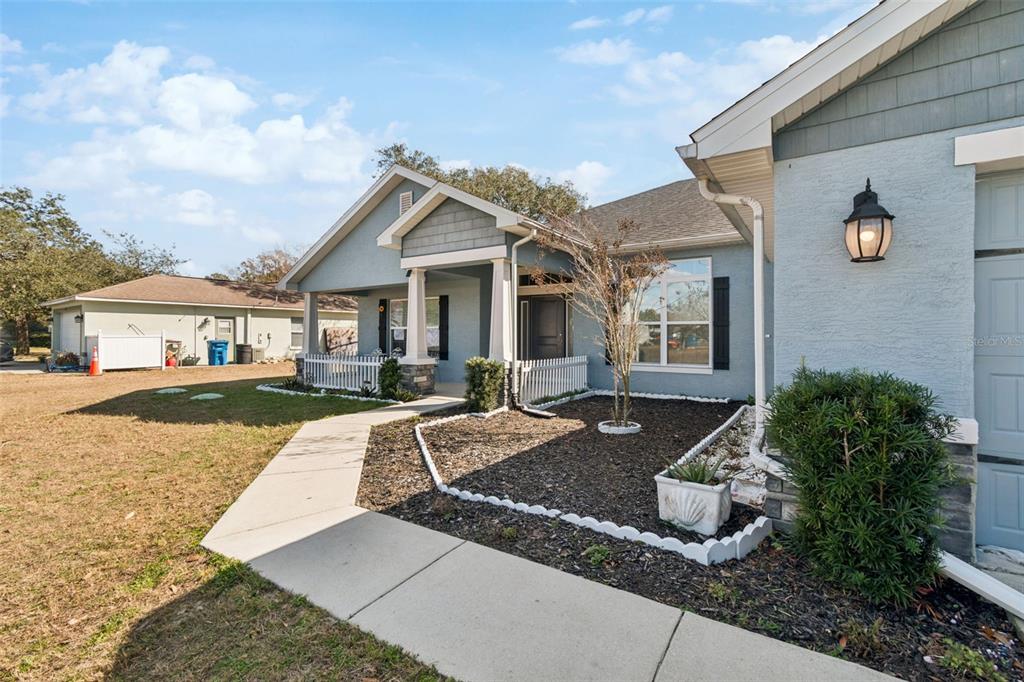 10358 Musa Road Spring Hill, FL 34608 - Photo 4 of 48 a front view of a house with garden