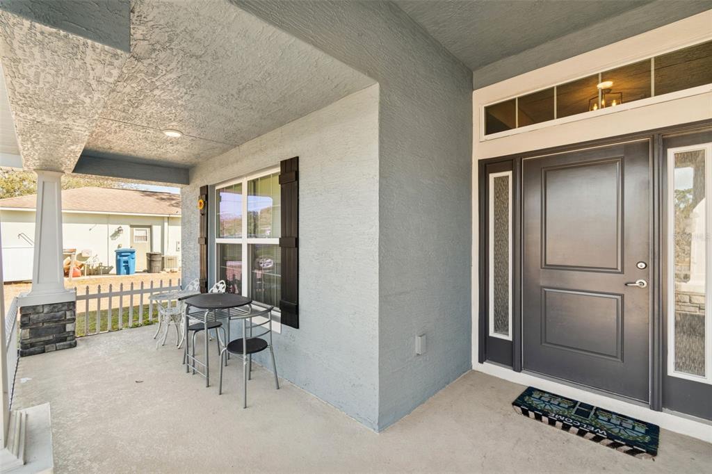 10358 Musa Road Spring Hill, FL 34608 - Photo 5 of 48 a view of a livingroom with floor to ceiling window and dining room
