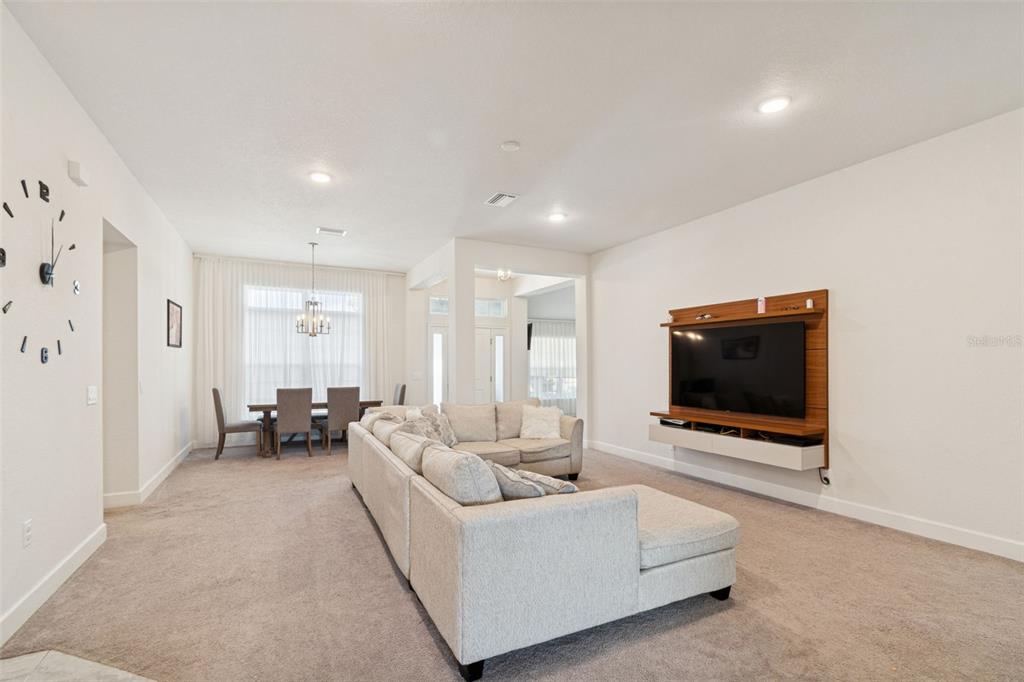 10358 Musa Road Spring Hill, FL 34608 - Photo 6 of 48 a living room with furniture and a flat screen tv