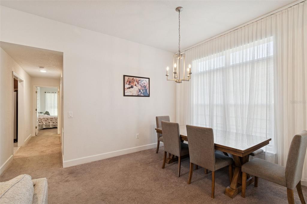 10358 Musa Road Spring Hill, FL 34608 - Photo 10 of 48 a view of a dining room with furniture and chandelier