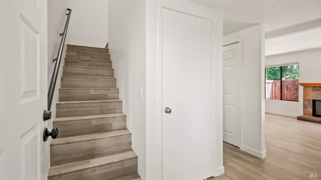 a view of a hallway with wooden floor and entryway