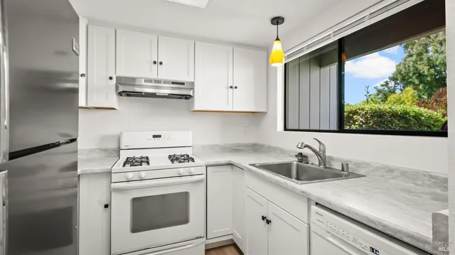 a kitchen with appliances cabinets and a sink