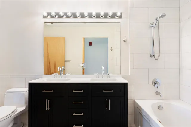 a view of a bathroom with a sink mirror and bathtub
