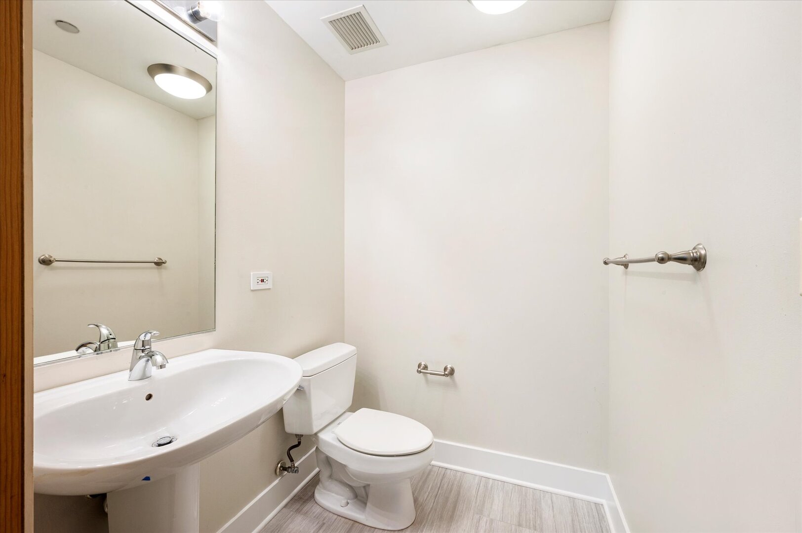 1720 South Michigan Avenue, Unit 1712 Chicago, IL 60616 - Photo 15 of 33 a bathroom with a sink toilet and a mirror