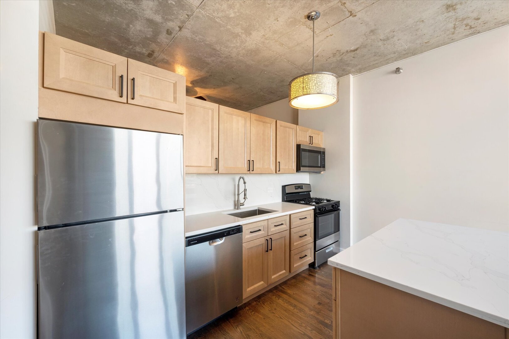 1720 South Michigan Avenue, Unit 1712 Chicago, IL 60616 - Photo 6 of 33 a kitchen with stainless steel appliances granite countertop a refrigerator a stove a sink and white cabinets