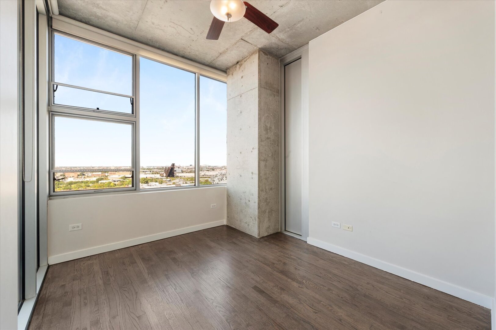 1720 South Michigan Avenue, Unit 1712 Chicago, IL 60616 - Photo 9 of 33 an empty room with wooden floor and windows