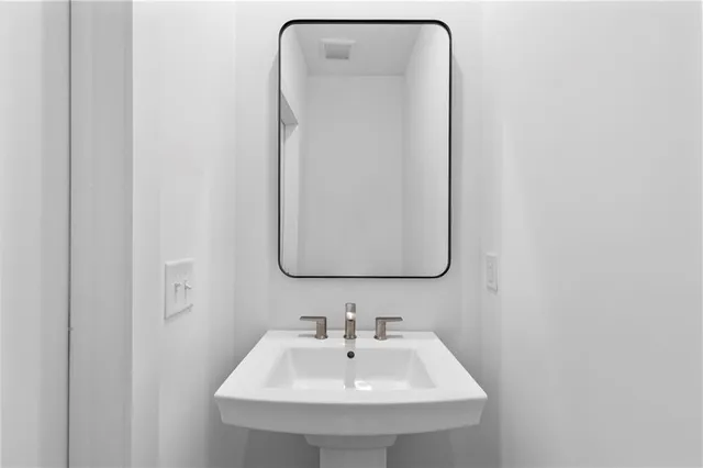 a bathroom with a sink and mirror