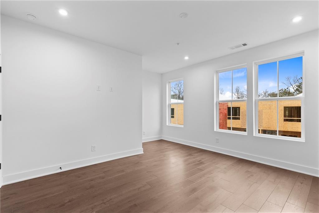 201 New Street, Unit 2304 Decatur, GA 30030 - Photo 15 of 28 a view of an empty room with a window and wooden floor