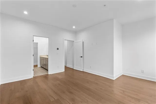 a view of an empty room with wooden floor