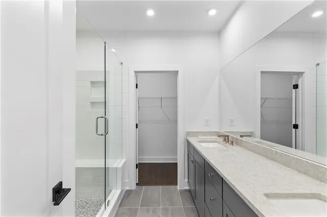 a bathroom with a granite countertop sink mirror and shower