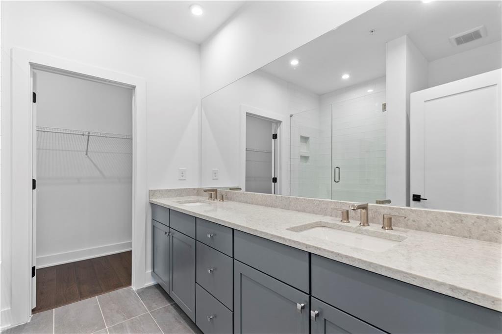 201 New Street, Unit 2304 Decatur, GA 30030 - Photo 18 of 28 a bathroom with a granite countertop sink double and mirror