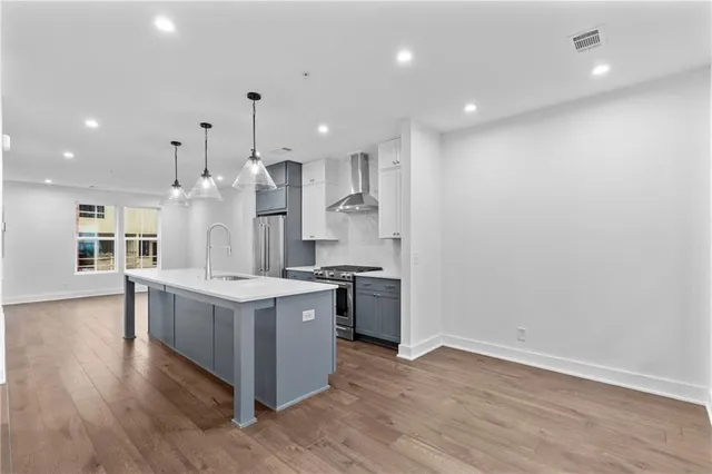 a large kitchen with a lot of counter top space and stainless steel appliances