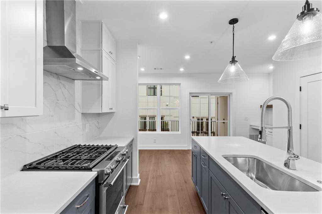 201 New Street, Unit 2304 Decatur, GA 30030 - Photo 9 of 28 a kitchen with stainless steel appliances granite countertop a sink stove and cabinets