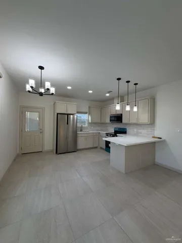 a large kitchen with stainless steel appliances kitchen island a large island in the center