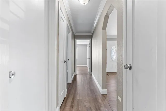 a view of a hallway with wooden floor and entryway