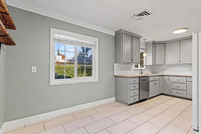 a kitchen with granite countertop white cabinets and white appliances