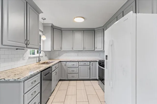 a kitchen with a sink stove and cabinets