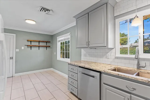 a kitchen with a sink cabinets and window