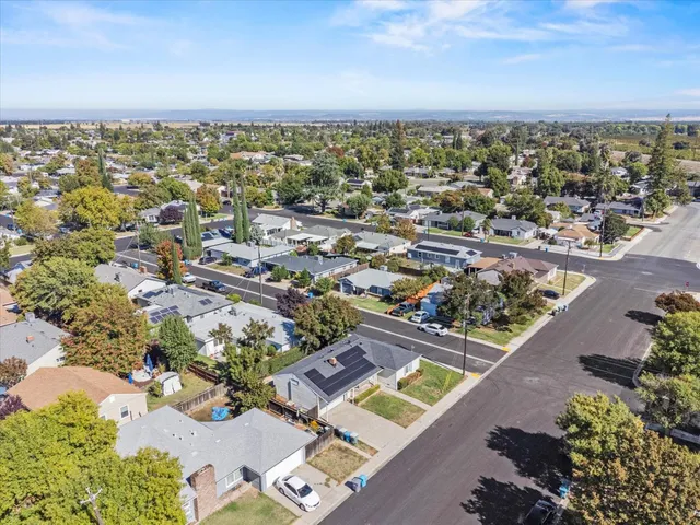 an aerial view of a house with a yard