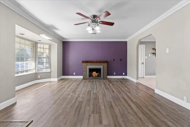 a view of an empty room with a fireplace and a window