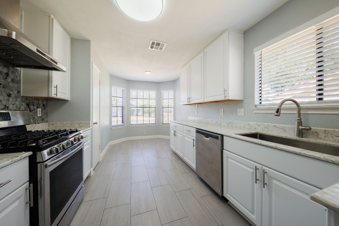 808 Primrose Lane Cedar Park, TX 78613 - Photo 1 of 1 a kitchen with granite countertop a sink a stove and cabinets
