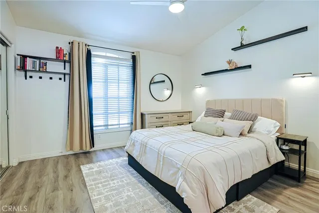 a bedroom with a large bed and a window