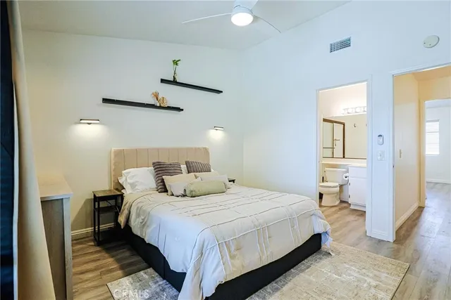 a bedroom with a bed and a lamp