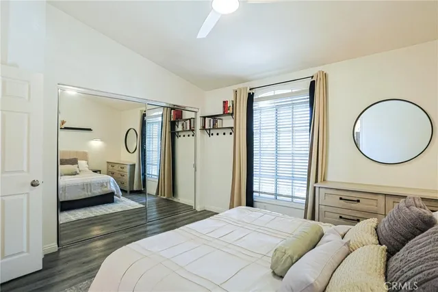a bedroom with a large bed and a mirror