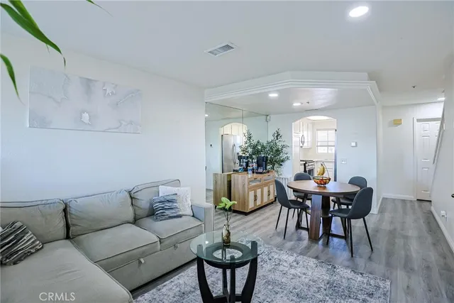 a living room with furniture a window and a dining table