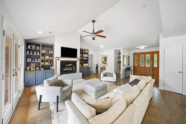 a living room with furniture a fireplace and a flat screen tv