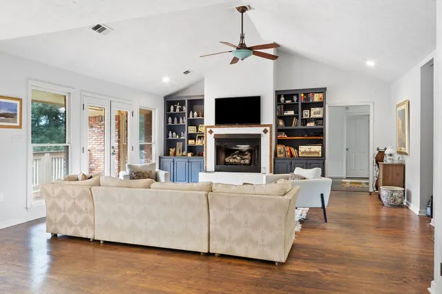 a living room with fireplace furniture and a flat screen tv