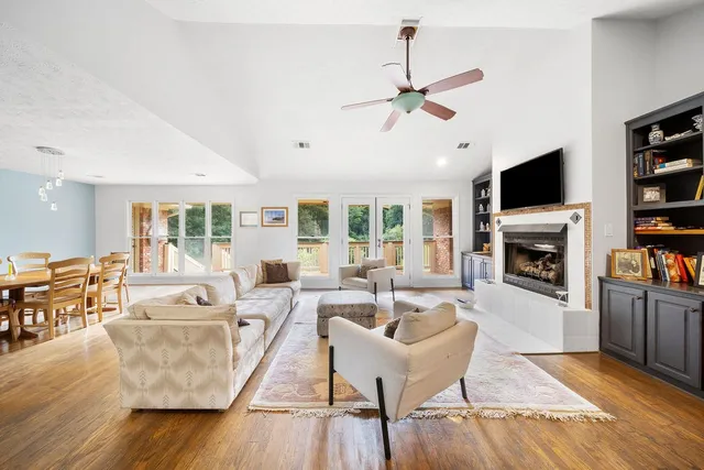 a living room with furniture fireplace and flat screen tv